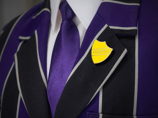 School boys blazer with yellow prefect school badge