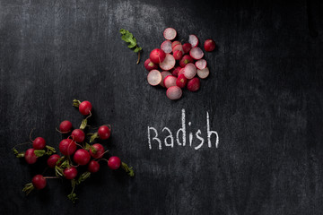 Cut radish over dark chalkboard background
