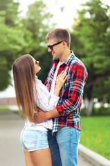 Obraz premium Happy young couple in love outdoors hugging at summer park
