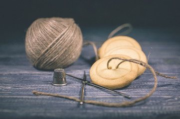 Home-made cookies in the form of buttons. Shortcake of original form on a wooden background. Soft vintage toning

