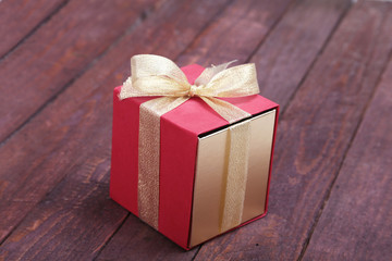 Beautiful gold, red present gift box and ribbons on backgound