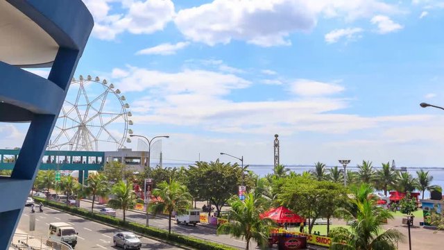 Timelapse view over Manila bay with ferry wheel at Mall of Asia, Manila, Philippines