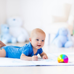 Baby boy playing with toy ball