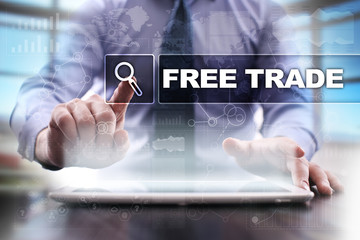 Businessman using tablet pc and selecting free trade.