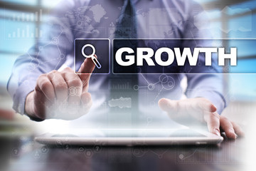 Fototapeta na wymiar Businessman using tablet pc and selecting growth .