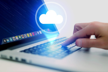 Concept of cloud storage icon flying out a computer - technology