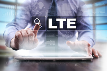 Fototapeta premium Businessman using tablet pc and selecting lte.