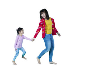 Obraz premium Woman and daughter running in studio