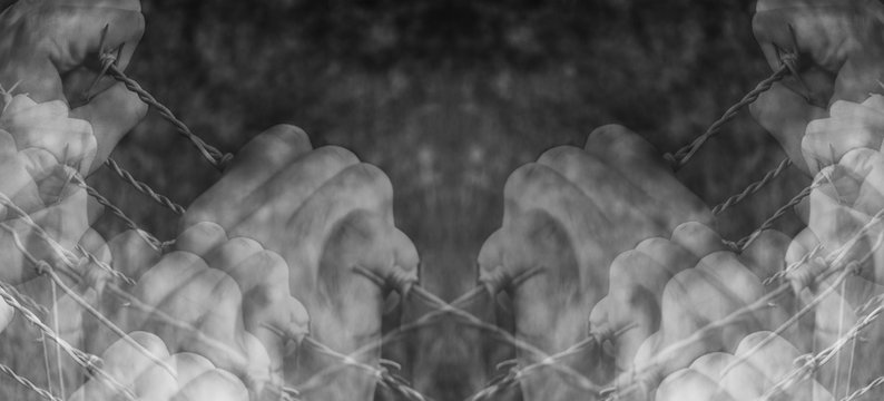 Lots of tortured hands grasping desperately barbed wire on black