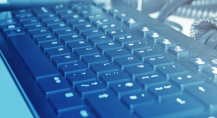 Dusty keyboard in blue light