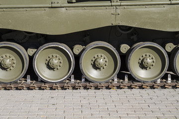 Fototapeta na wymiar Heavy Military tank, detail of tracks or wheels of the off-road