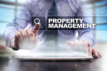 Fototapeta na wymiar Businessman using tablet pc and selecting property management.