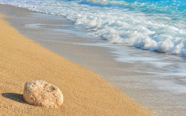 Soft golden greece beach with wave in the background 