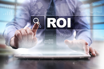 Businessman using tablet pc and selecting roi.