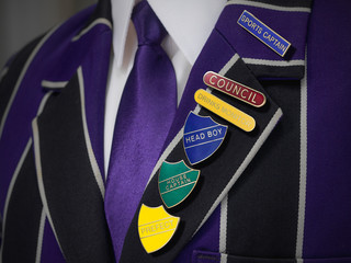 School boys blazer with school numerous badges
