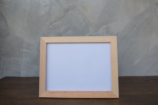 photo Frame on a wooden on Gray wall background .