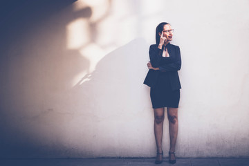 Business women standing side wall in evening