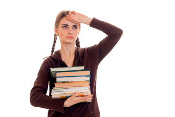 tired young students girl with a lot of books in her hands isolated on white background