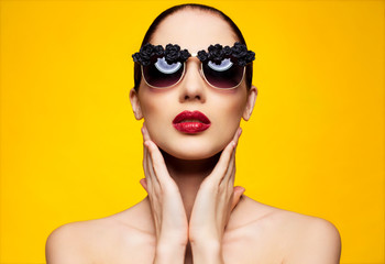 woman in glasses over yellow background