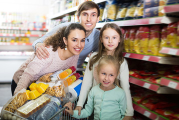 Cheerful family with two daughters shopping