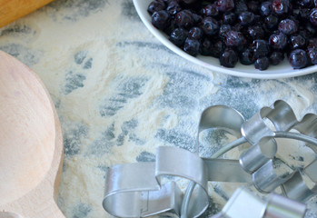 Cooking cookies with blueberries: flour, berries, molds and rolling pin