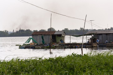 Fototapeta na wymiar Fish farm houses floating on Mekong river, My Tho, Vietnam