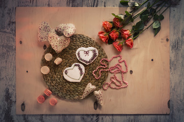 gingerbread, macaroon, rose and heart pillow on the table