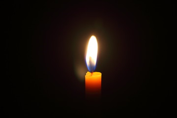 Lighting candles on a black background.