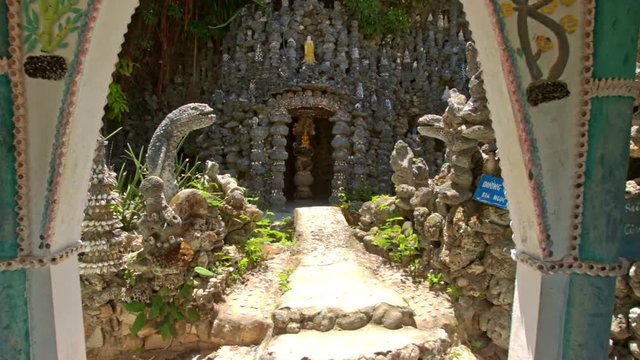 Path to Modern Church Built with Crude Stones Through Gate
