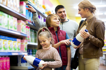 Family of customers with children purchasing milk