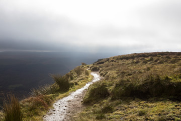 The Path Along the Escarpment. A public walking path goes along the escarpment of Craig y Fan Ddu in the Brecon Beacon National Park taking no notice of the long drop to the valley below.
