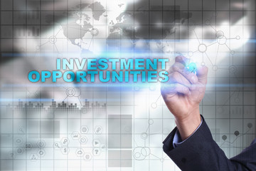 Businessman is drawing on virtual screen. investment opportunities concept.