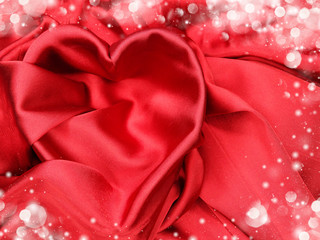 red satin material with heart shape love concept