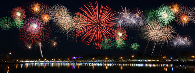 Reflecting on the water surface, work a fireworks display to celebrate great day.