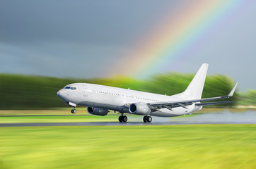 Fototapeta na wymiar Airplane Airport take off in the rain on a background a rainbow