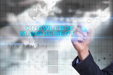 Businessman is drawing on virtual screen. knowledge management concept.