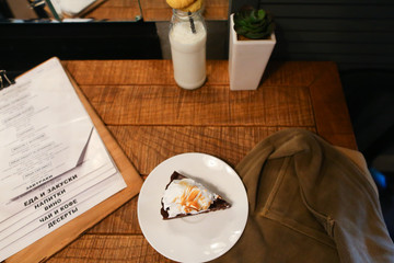 Piece pie, menu, glass bottle of milk, plant in vase and marsh d