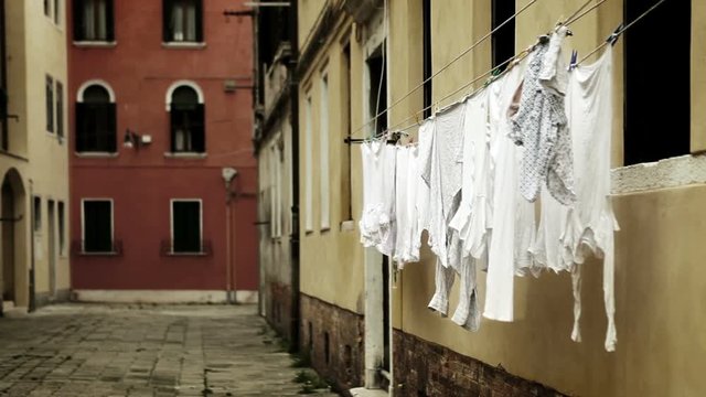 Laundry hangs drying on the narrow street in Venice