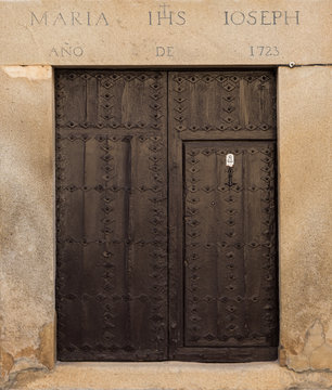 Ancient door dating in 1723 according inscription on the lintel. Old town of Orgaz. Spain.