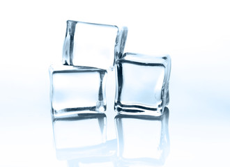 Transparent ice cubes with reflection isolated on white.