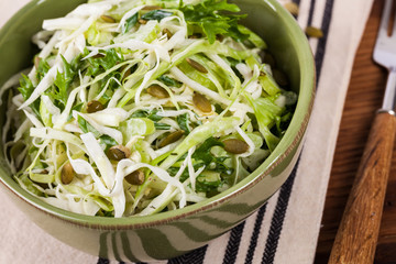 Coleslaw Cabbage Salad with Pumpkin Seeds. Selective focus.