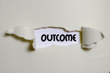 The word outcome appearing behind torn paper