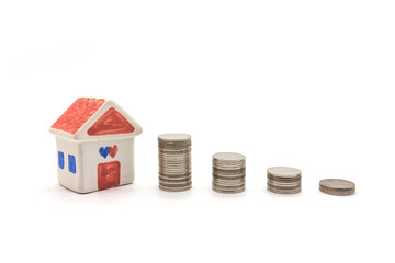 house and coins on white background