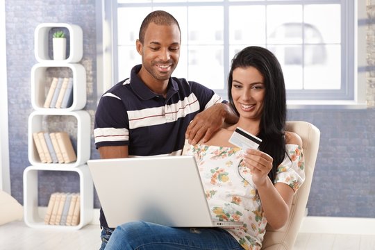 Diverse couple e-shopping at home
