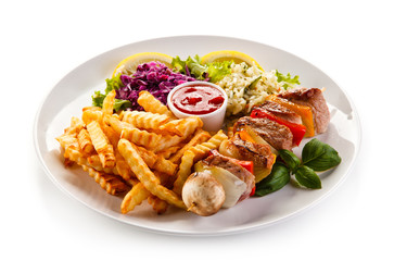 Kebabs - grilled meat and vegetables on white background 