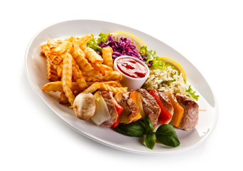 Kebabs - grilled meat and vegetables on white background 