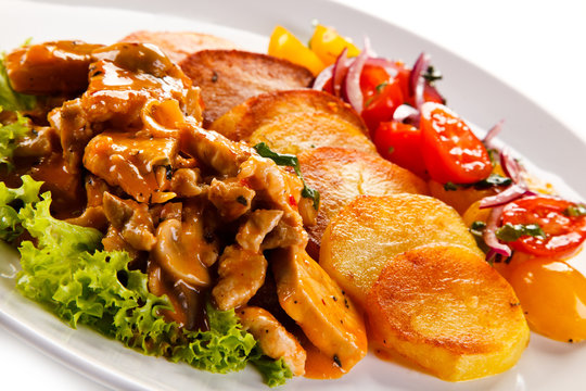 Goulash with baked potatoes and vegetables 