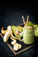 Fresh blended Banana and avocado smoothie with yogurt or milk in mason jar, healthy eating, superfood