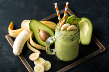 Fresh blended Banana and avocado smoothie with yogurt or milk in mason jar, healthy eating, superfood - obrazy, fototapety, plakaty