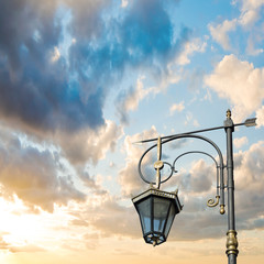 Silhouette of a street lamp on the background of the beautiful s